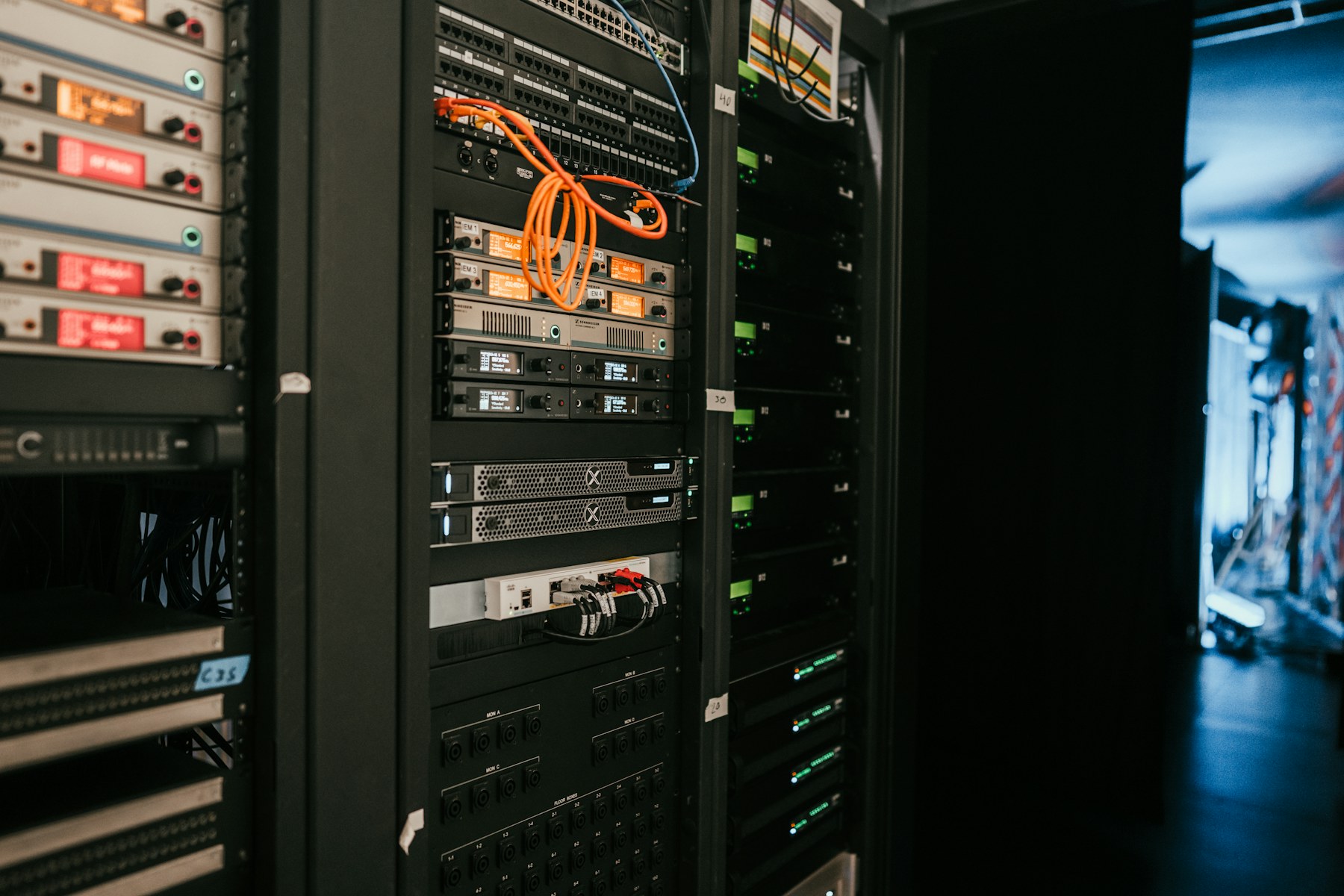 Server racks with network switches and orange cables